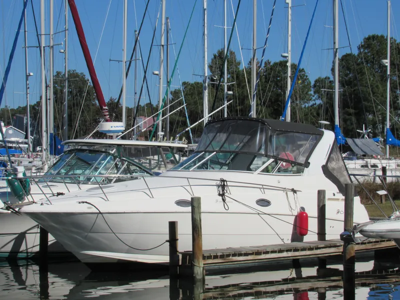 Slide: The Image of 2003 Cruisers Yachts 2870 Express docked at marina with sailboats. - 6