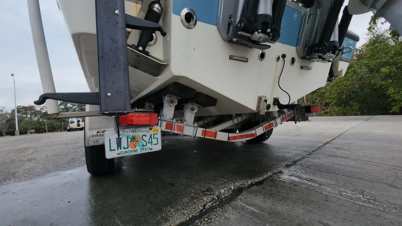 Slide: The Image of 2019 Mako 284 CC boat on trailer, rear view, Florida license plate visible. - 16