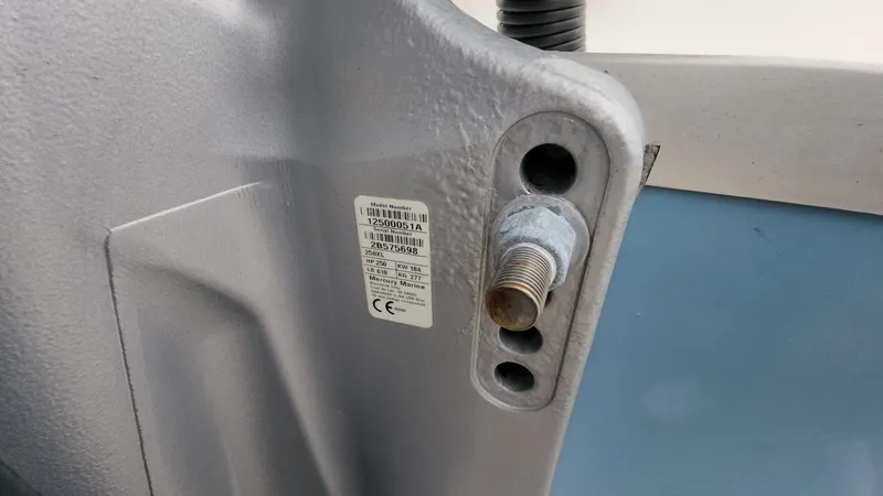 Slide: The Image of Close-up of a 2019 Mako 284 CC boat component with a label and bolt. - 23