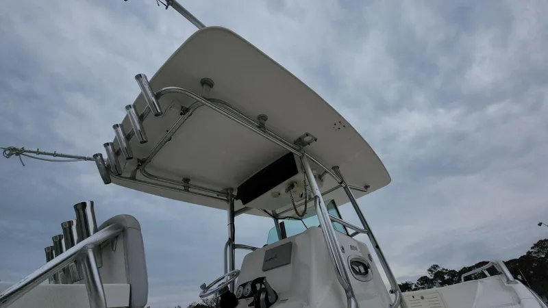 Slide: The Image of 2019 Mako 284 CC boat with T-top under cloudy sky. - 24