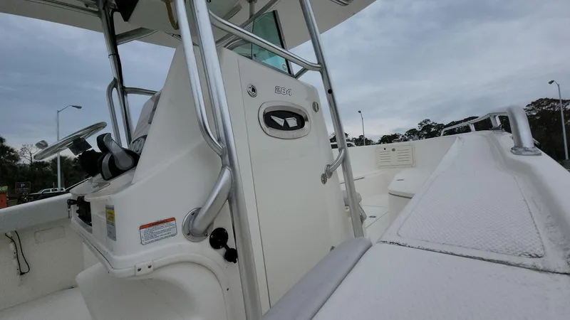 Slide: The Image of 2019 Mako 284 CC boat console with stainless steel railings and white deck. - 25
