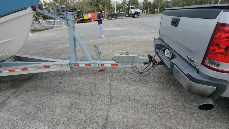 Slide: The Image of Truck towing a 2019 Mako 284 CC boat on a trailer in a parking lot. - 27