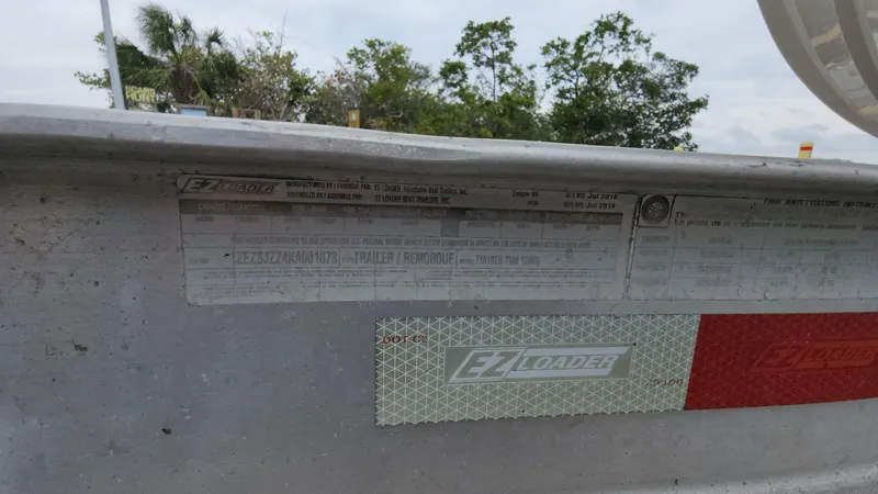 Slide: The Image of 2019 Mako 284 CC boat trailer with EZ Loader label and specifications. - 30