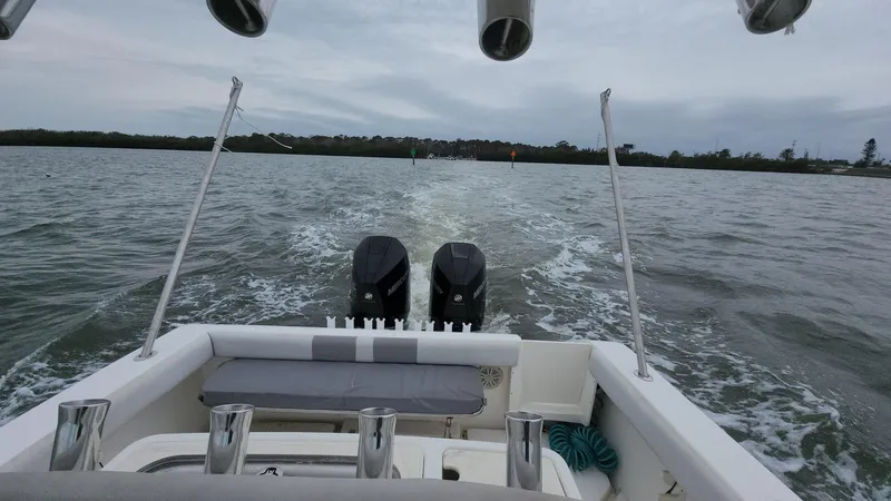 Slide: The Image of 2019 Mako 284 CC boat on water, rear view with dual engines. - 35