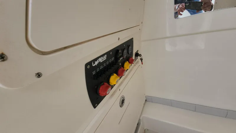 Slide: The Image of Control panel of a 2019 Mako 284 CC boat with switches and labels. - 44