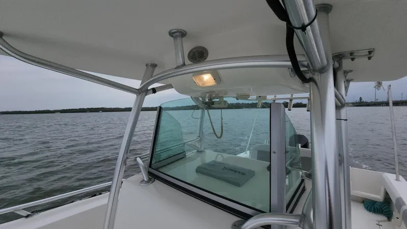 Slide: The Image of 2019 Mako 284 CC boat on water, featuring a sleek design and sturdy structure. - 45