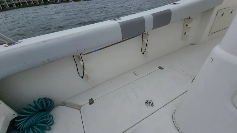 Slide: The Image of 2019 Mako 284 CC boat interior with storage compartments and coiled rope. - 48