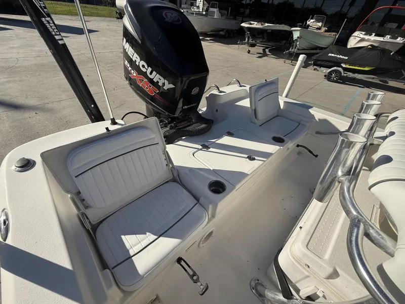 Slide: The Image of 2013 NauticStar 2200 T boat interior with Mercury engine and seating. - 16