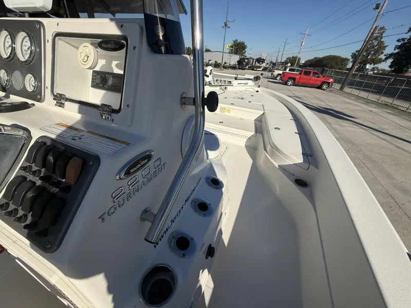 Slide: The Image of 2013 NauticStar 2200 T boat dashboard and deck, featuring gauges and controls. - 17