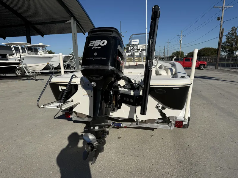 Slide: The Image of 2013 NauticStar 2200 T boat with 250 Pro outboard motor, parked outdoors. - 18