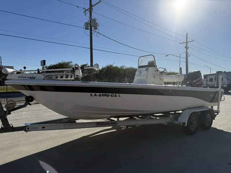Slide: The Image of 2013 NauticStar 2200 T boat on trailer, sunny day, side view. - 8