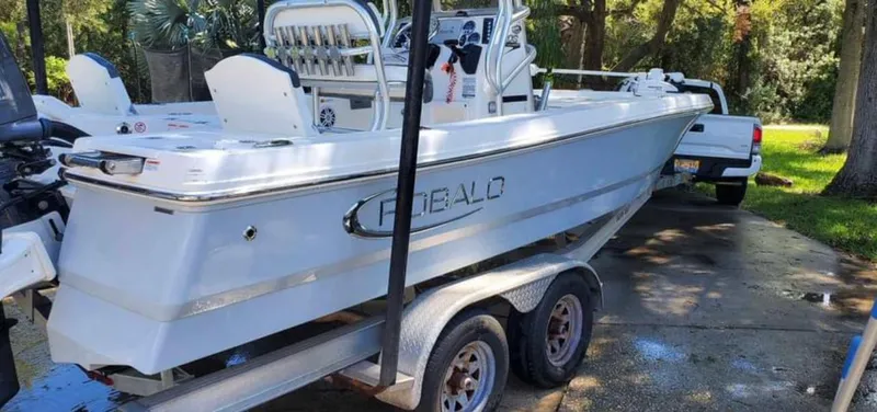 Slide: The Image of 2019 Robalo 206 Cayman boat on trailer, parked outdoors. - 1