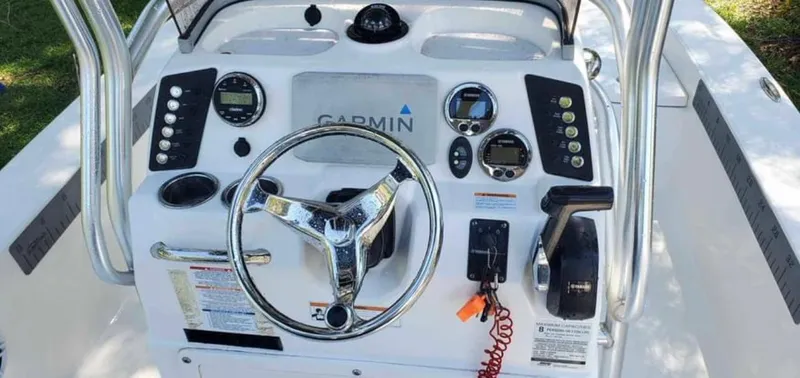 Slide: The Image of 2019 Robalo 206 Cayman boat dashboard with Garmin navigation system and controls. - 3