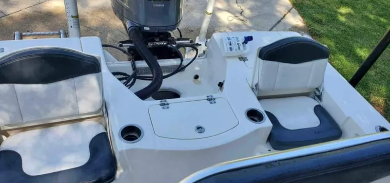 Slide: The Image of 2019 Robalo 206 Cayman boat interior with seating and motor. - 4