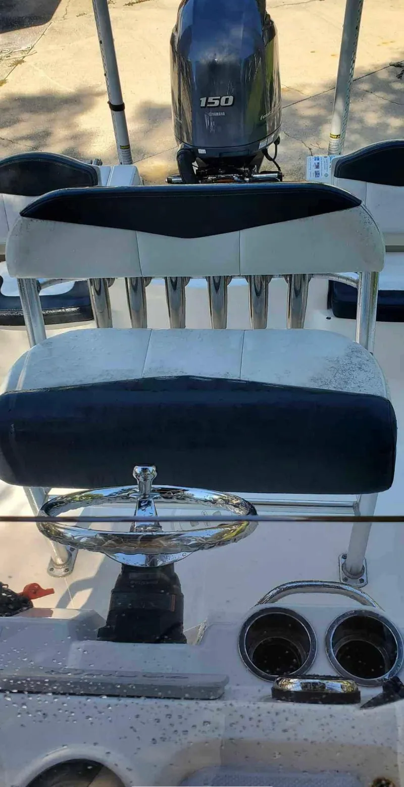 Slide: The Image of 2019 Robalo 206 Cayman boat interior with steering wheel and Yamaha 150 engine. - 7