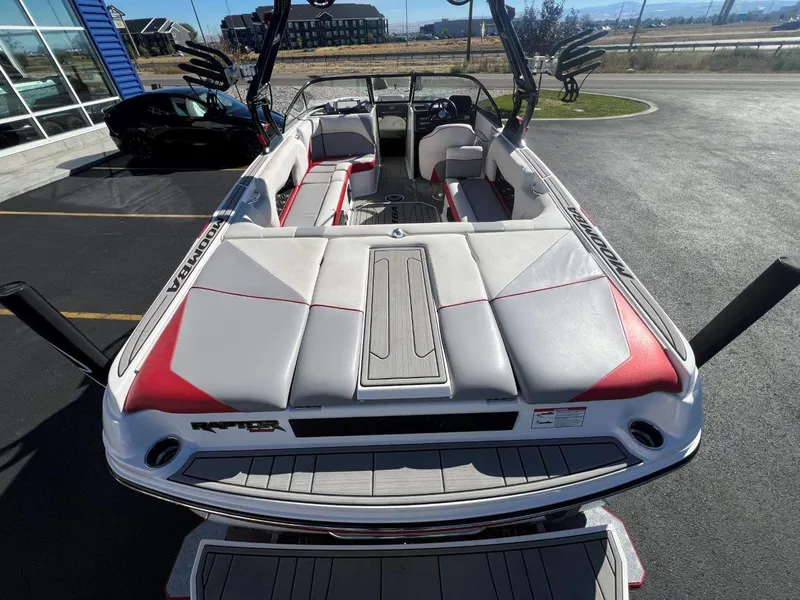 Slide: The Image of 2019 Moomba Mojo boat with red and white interior, parked outdoors. - 10