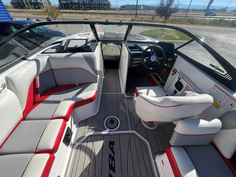 Slide: The Image of 2019 Moomba Mojo boat interior with red and white seating, steering wheel, and dashboard. - 12