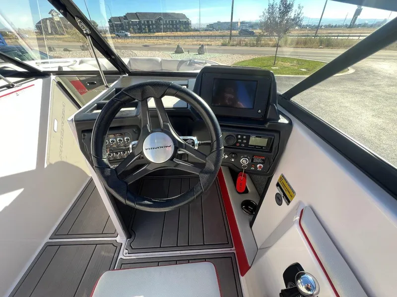 Slide: The Image of 2019 Moomba Mojo boat cockpit with steering wheel and control panel. - 13