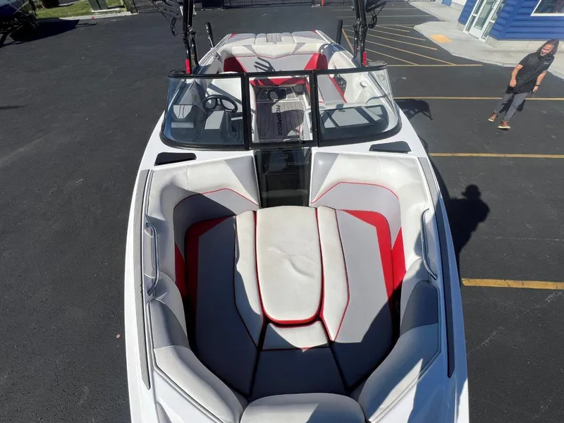 Slide: The Image of 2019 Moomba Mojo boat with red and white interior, parked in a lot. - 17