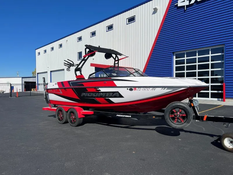 Slide: The Image of 2019 Moomba Mojo boat on trailer, parked outside a modern building. - 4