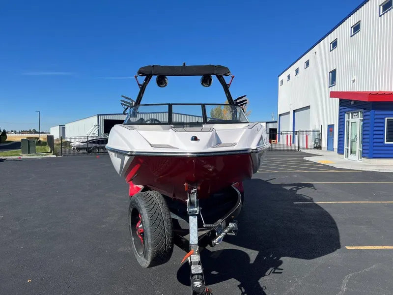 Slide: The Image of 2019 Moomba Mojo boat on trailer in parking lot, clear blue sky background. - 5