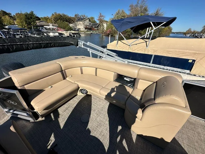 Slide: The Image of 2020 Harris Cruiser 210 SL pontoon boat with tan seating, docked by a scenic lake. - 10