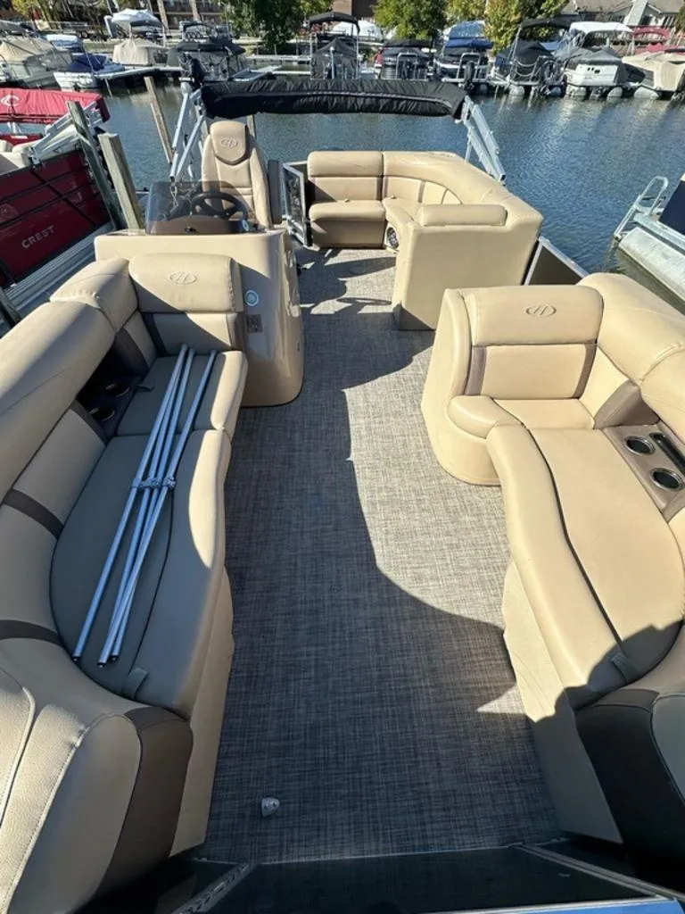 Slide: The Image of 2020 Harris Cruiser 210 SL pontoon boat with beige seating, docked at a marina. - 4
