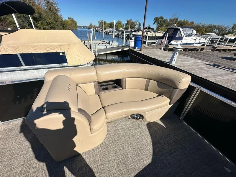 Slide: The Image of 2020 Harris Cruiser 210 SL boat with beige seating at a marina. - 5