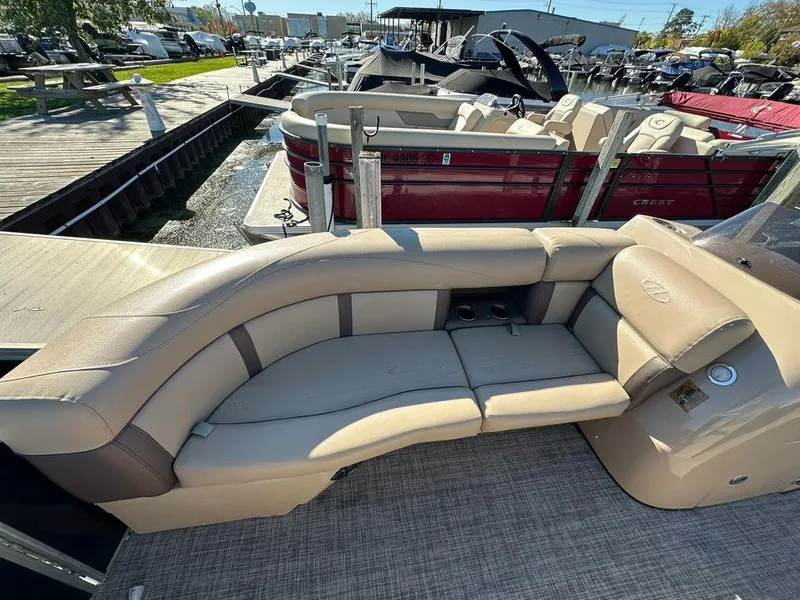 Slide: The Image of 2020 Harris Cruiser 210 SL pontoon boat with beige seating at a marina. - 6