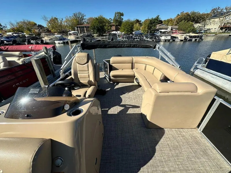 Slide: The Image of 2020 Harris Cruiser 210 SL pontoon boat with beige seating, docked at a marina. - 7