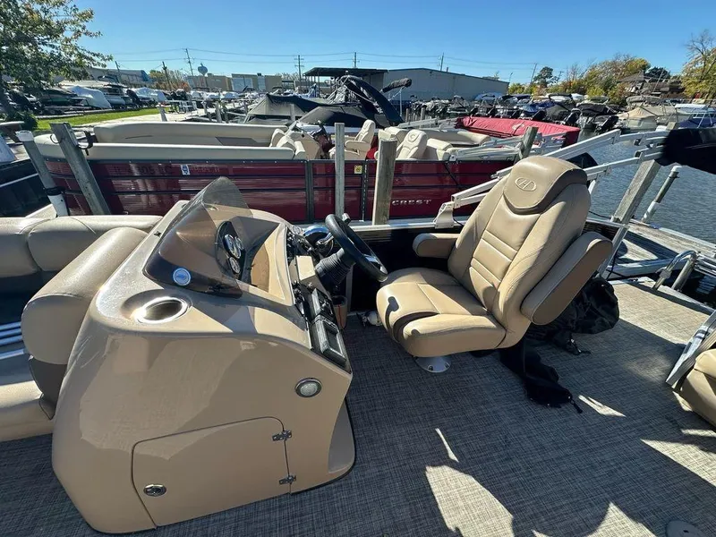 Slide: The Image of 2020 Harris Cruiser 210 SL boat interior with steering console and seating. - 8