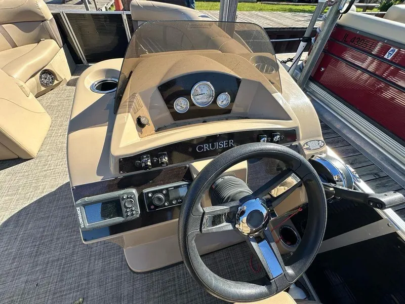 Slide: The Image of 2020 Harris Cruiser 210 SL boat dashboard with steering wheel and controls. - 9