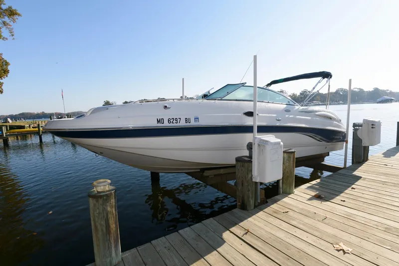 Slide: The Image of 2005 Chaparral Sunesta 274 boat docked on a sunny day by the water. - 1