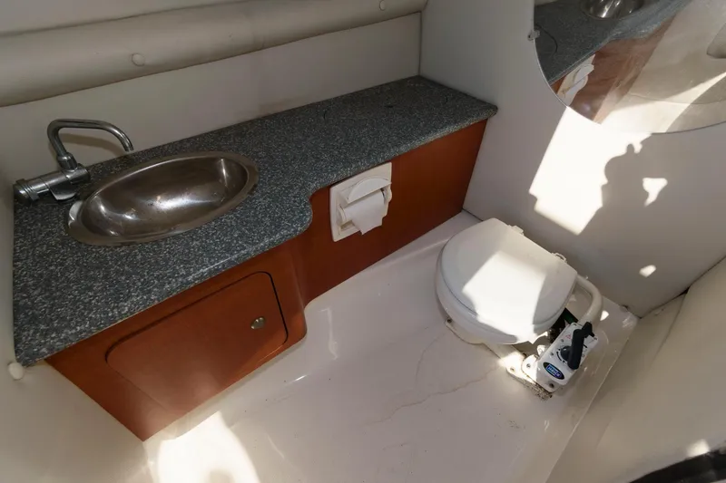 Slide: The Image of 2005 Chaparral Sunesta 274 boat bathroom with sink and toilet. - 11