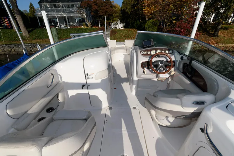 Slide: The Image of 2005 Chaparral Sunesta 274 boat interior with steering wheel and seating. - 3