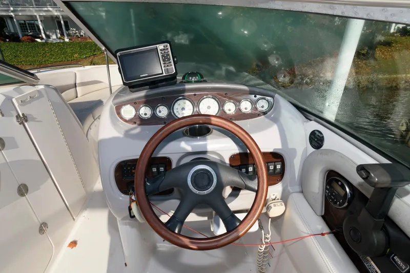 Slide: The Image of 2005 Chaparral Sunesta 274 boat dashboard with steering wheel and navigation system. - 5