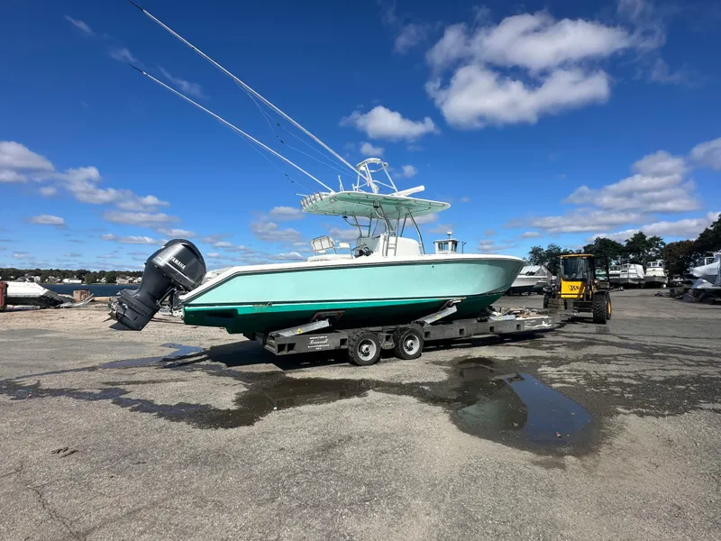 Slide: The Image of 2003 Venture 34 Open boat on trailer under clear blue sky. - 3