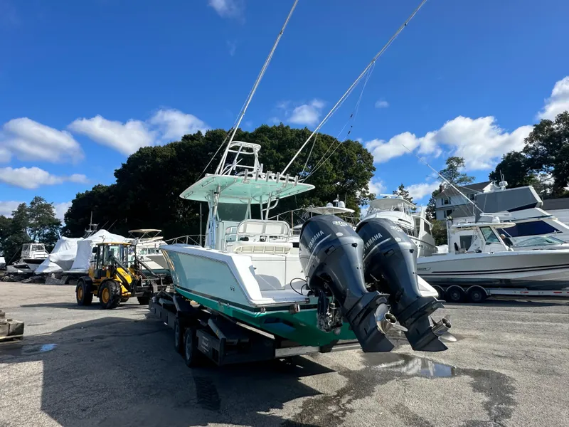 Slide: The Image of 2003 Venture 34 Open boat with dual Yamaha engines on a trailer, under a clear blue sky. - 4