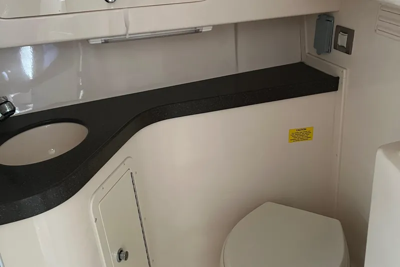 Slide: The Image of 2009 Grady-White Express 330 boat interior with sink and toilet. - 12
