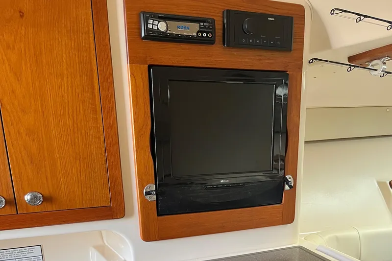 Slide: The Image of 2009 Grady-White Express 330 cabin with built-in TV and audio system. - 14