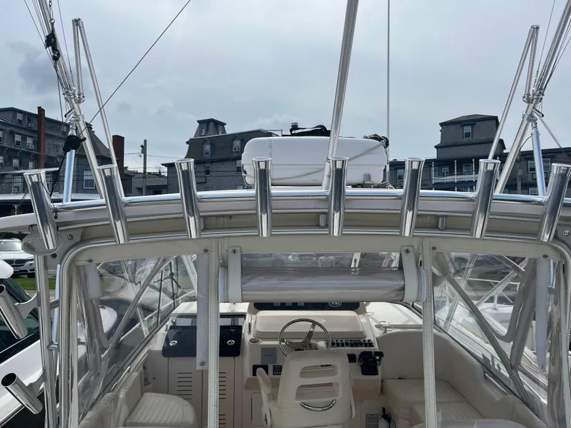 Slide: The Image of 2009 Grady-White Express 330 boat interior with rod holders and steering wheel. - 6