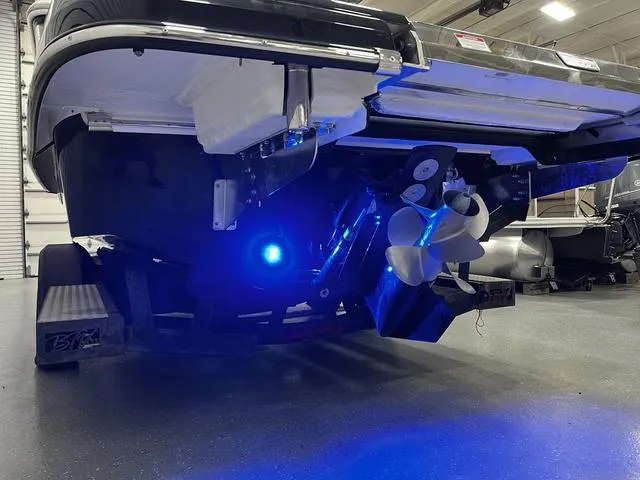 Slide: The Image of 2024 Chaparral 287 SSX boat with illuminated blue underwater lights and dual propellers. - 10
