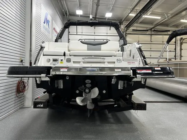 Slide: The Image of 2024 Chaparral 287 SSX boat in showroom, rear view with propeller and swim platform. - 8