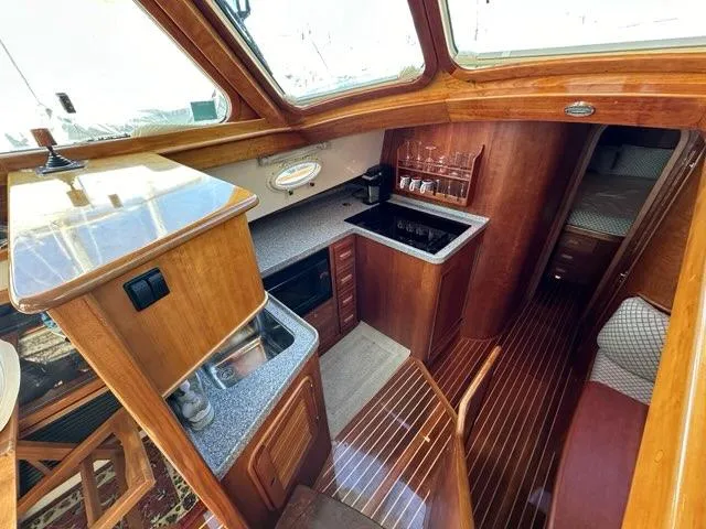 Slide: The Image of 2003 Hinckley Talaria 44 FB yacht interior with wood finish and modern kitchen amenities. - 13
