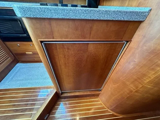 Slide: The Image of 2003 Hinckley Talaria 44 FB interior with wood cabinetry and granite countertop. - 18