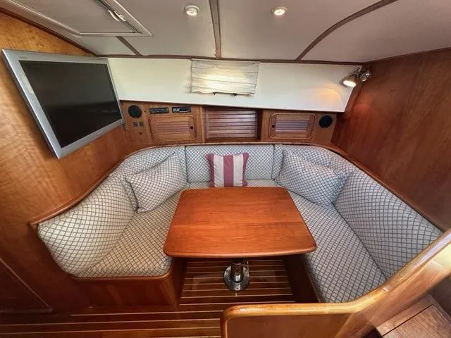 Slide: The Image of 2003 Hinckley Talaria 44 FB yacht interior with cozy seating and wooden table. - 20