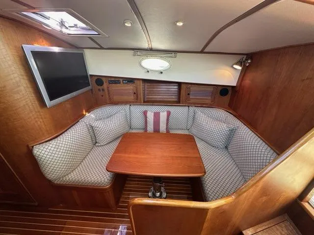Slide: The Image of 2003 Hinckley Talaria 44 FB yacht interior with cozy seating and wooden table. - 21