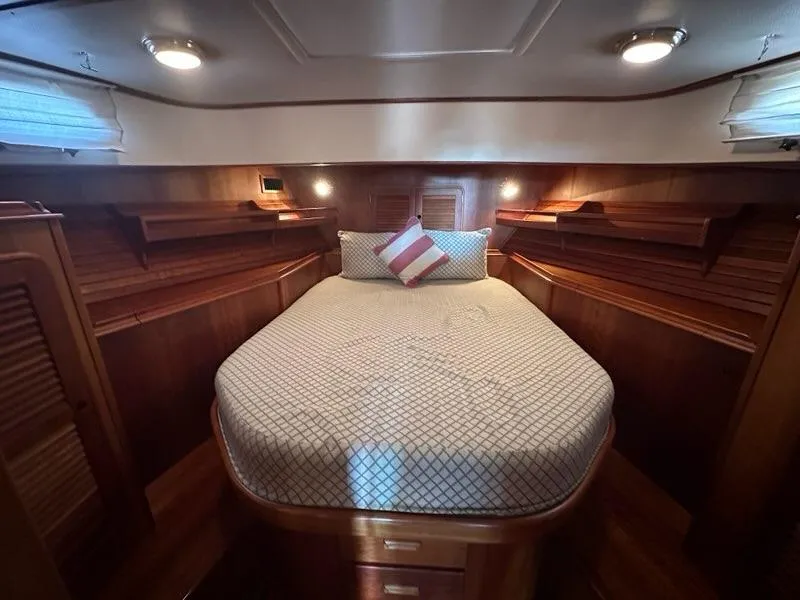 Slide: The Image of Luxurious 2003 Hinckley Talaria 44 FB yacht cabin with cozy bed and wooden interior. - 25
