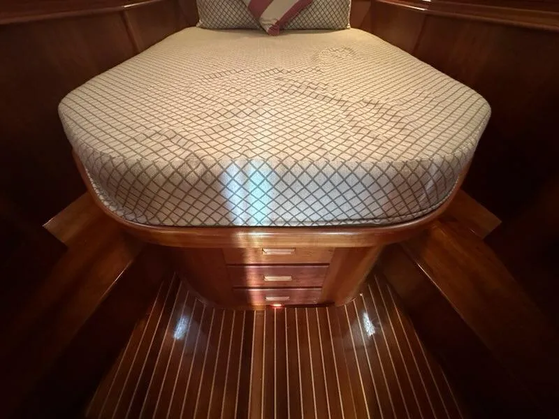 Slide: The Image of Luxurious cabin interior of 2003 Hinckley Talaria 44 FB with wooden finish and cozy bedding. - 28
