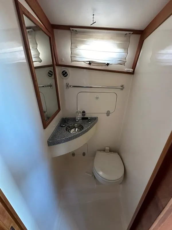 Slide: The Image of Bathroom interior of 2003 Hinckley Talaria 44 FB yacht with sink and toilet. - 30